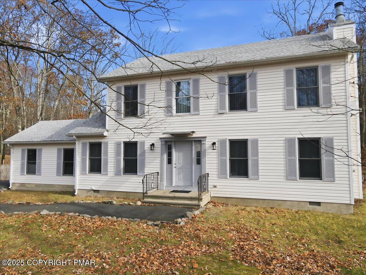 2312 Cramer Court Bushkill, PA 18324 - Photo 6 of 107 a view of a white house with large windows next to a yard
