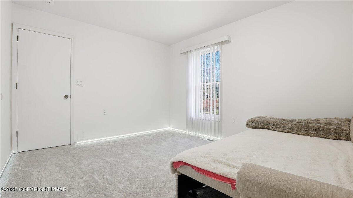 2312 Cramer Court Bushkill, PA 18324 - Photo 62 of 107 a bedroom with a bed and a window