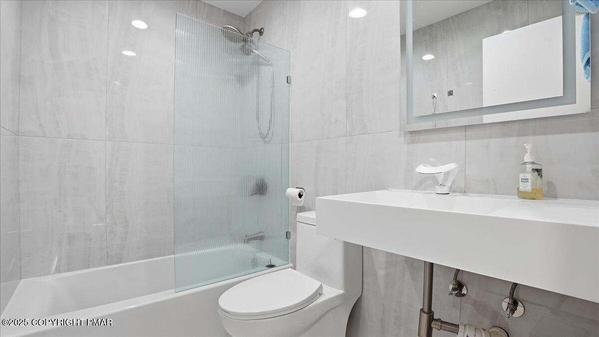 2312 Cramer Court Bushkill, PA 18324 - Photo 67 of 107 a bathroom with a sink a toilet a mirror and shower