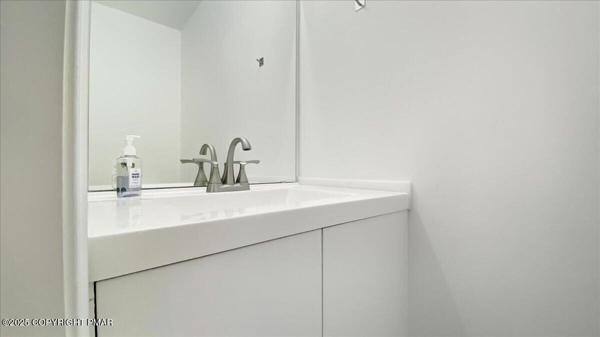 2312 Cramer Court Bushkill, PA 18324 - Photo 69 of 107 a bathroom with a sink and a mirror