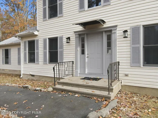 a living room with furniture a window and a fireplace