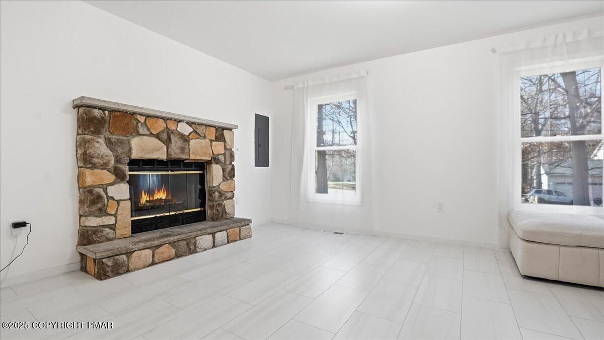 2312 Cramer Court Bushkill, PA 18324 - Photo 10 of 107 a living room with furniture a window and a fireplace