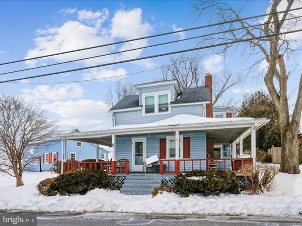 a front view of a building with potted plants