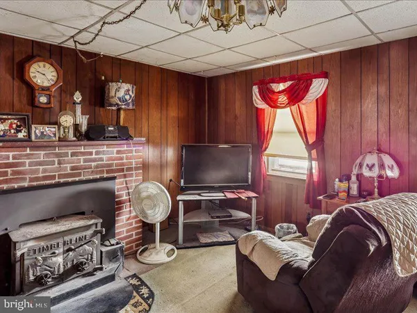 a living room with furniture a fireplace and a window