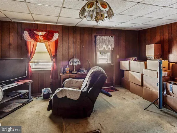 a living room with furniture a window and a flat screen tv