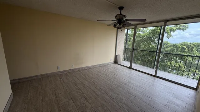 a view of a room with wooden floor and balcony