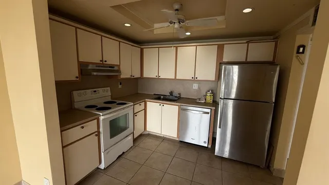 a kitchen with stainless steel appliances a refrigerator sink and microwave