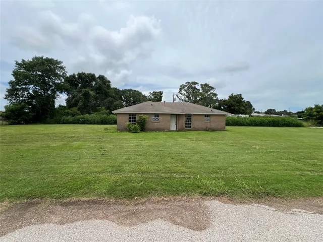 a aerial view of a house with yard and fence