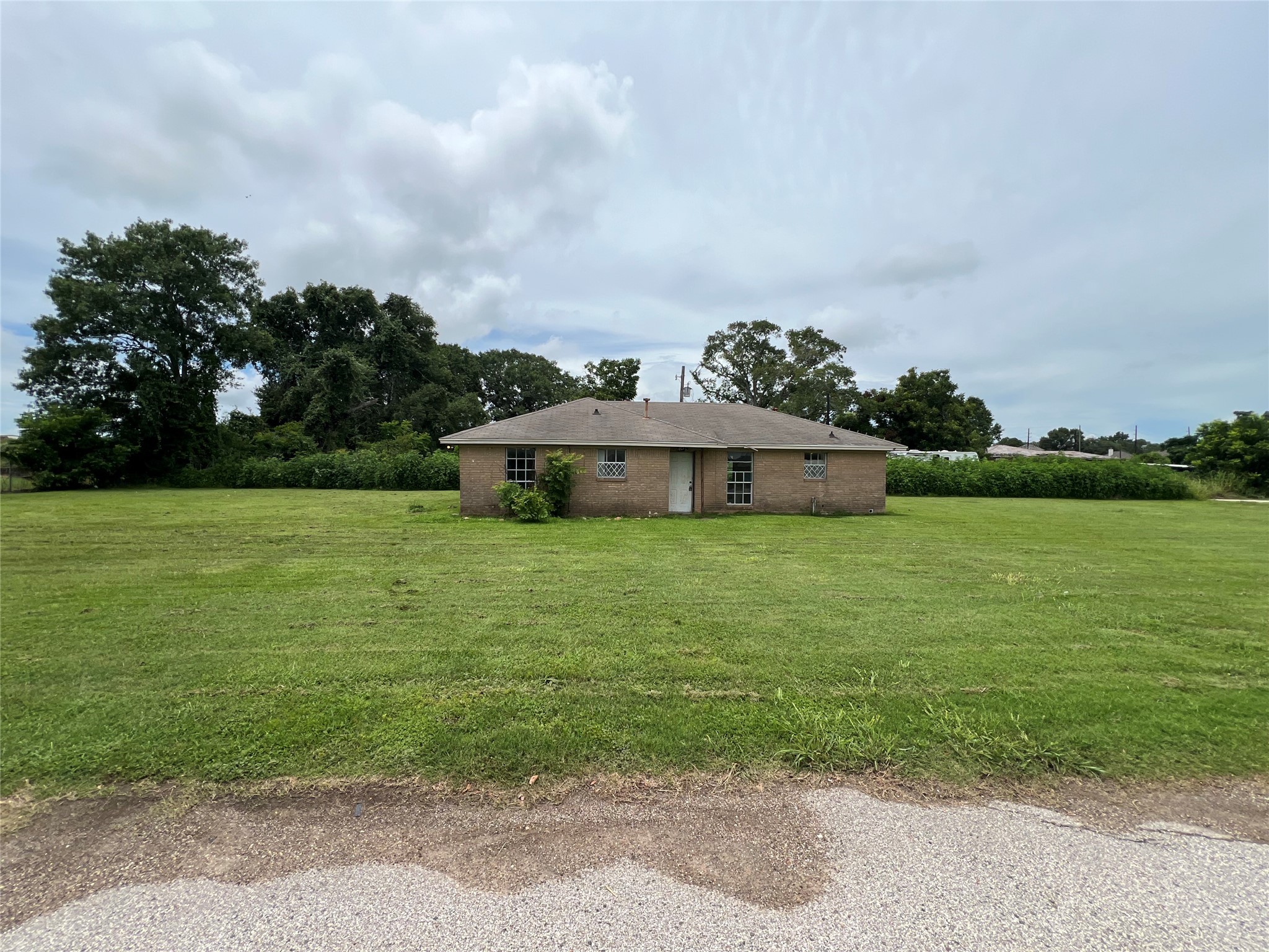 a aerial view of a house with yard and fence