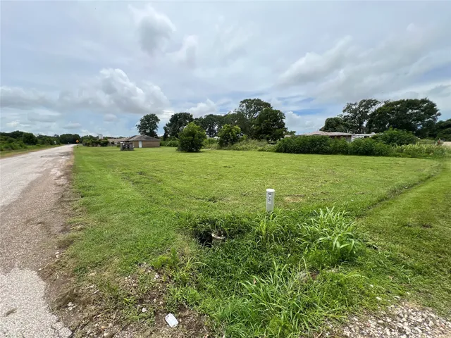 a view of a big yard with lots of green space