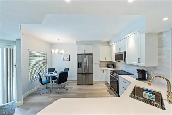 a kitchen with refrigerator and cabinets