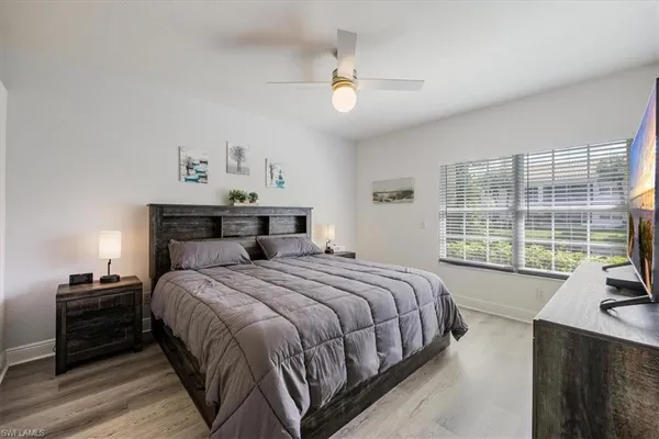 a bedroom with a large bed and a large window