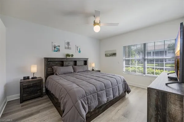 a bedroom with a large bed and a large window