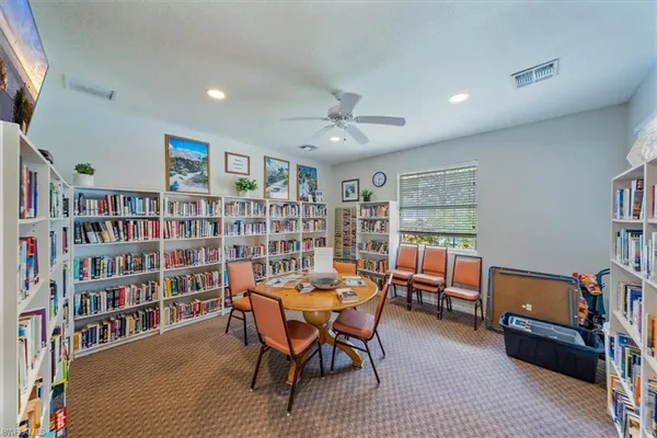 a view of a workspace with furniture and a bookshelf