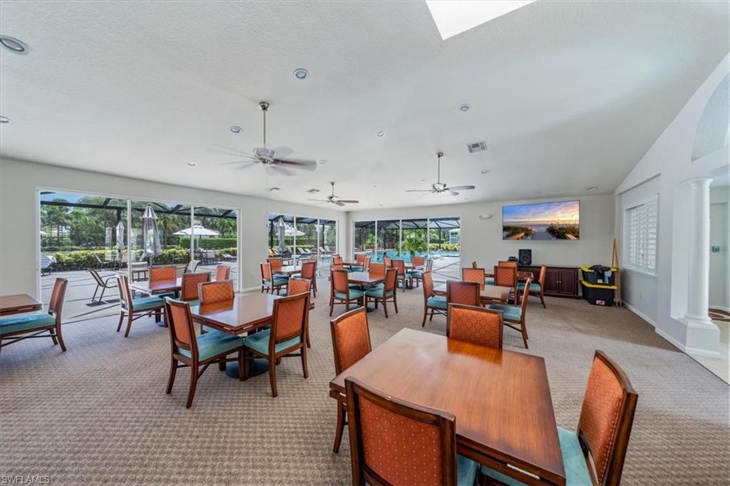 6914 Satinleaf Road North, Unit 103 Naples, FL 34109 - Photo 33 of 34 a view of a dining room with furniture