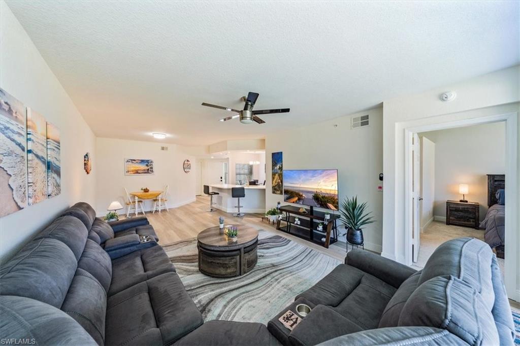 6914 Satinleaf Road North, Unit 103 Naples, FL 34109 - Photo 4 of 34 a living room with furniture kitchen view and a couch