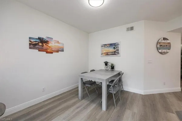 a view of a workspace with furniture and wooden floor