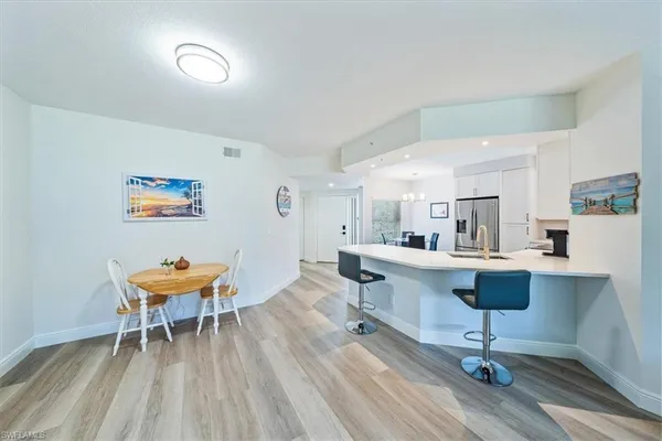 a view of a room with furniture and wooden floor