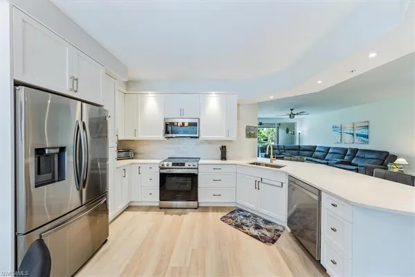 a kitchen with a sink stove and refrigerator