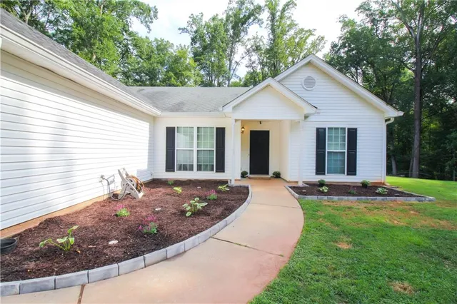a front view of house with yard outdoor seating and green space