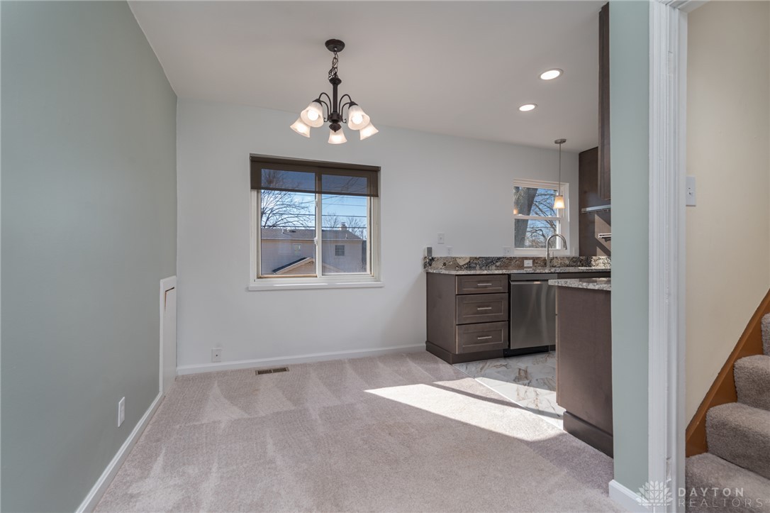 326 North Bromfield Road Kettering, OH 45429 - Photo 7 of 30 This bright and airy space features a modern kitchen and inviting dining area.