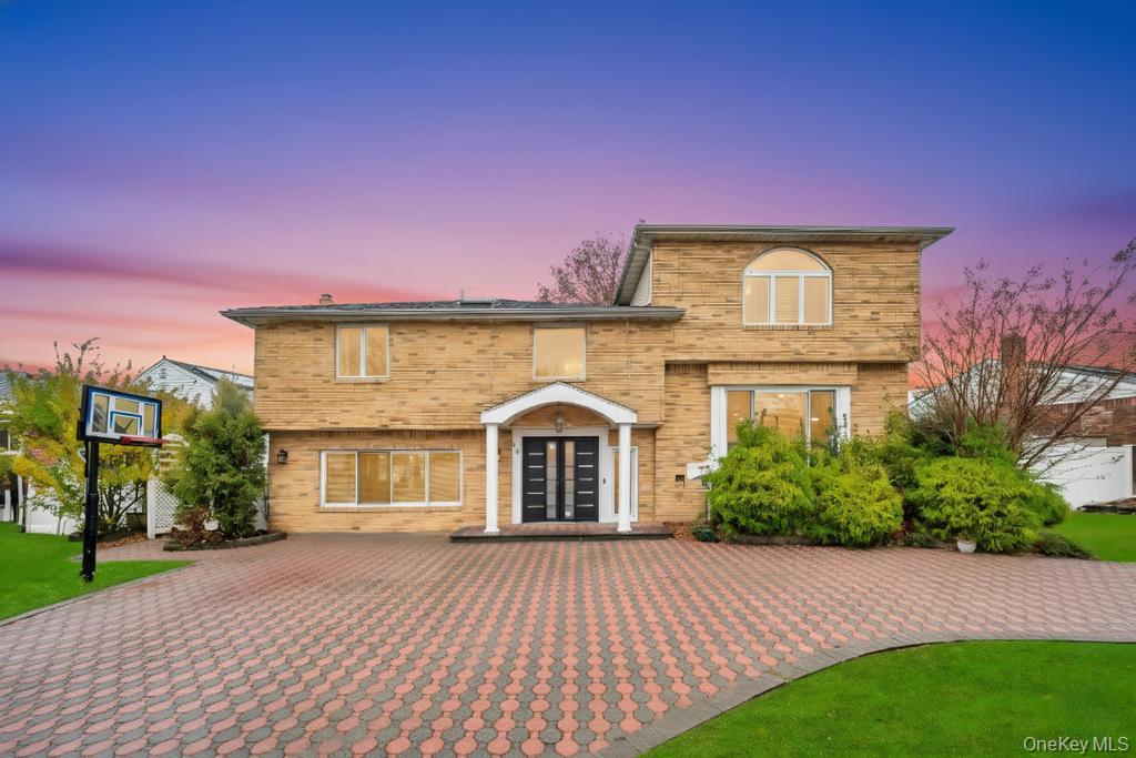 64 Fox Place Hicksville, NY 11801 - Photo 2 of 25 View of front facade with brick siding and a yard