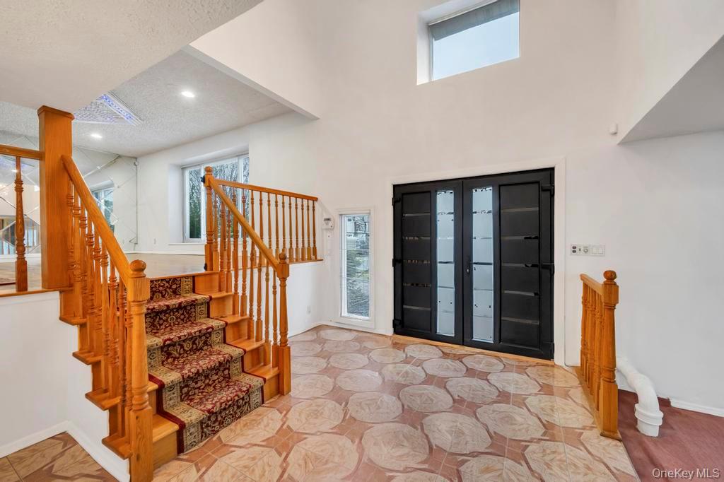 64 Fox Place Hicksville, NY 11801 - Photo 4 of 25 Foyer featuring stairway and a textured ceiling
