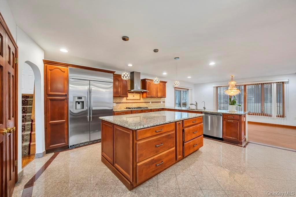64 Fox Place Hicksville, NY 11801 - Photo 5 of 25 Kitchen featuring granite tiled floors, appliances with stainless steel finishes, light stone countertops, and recessed lighting