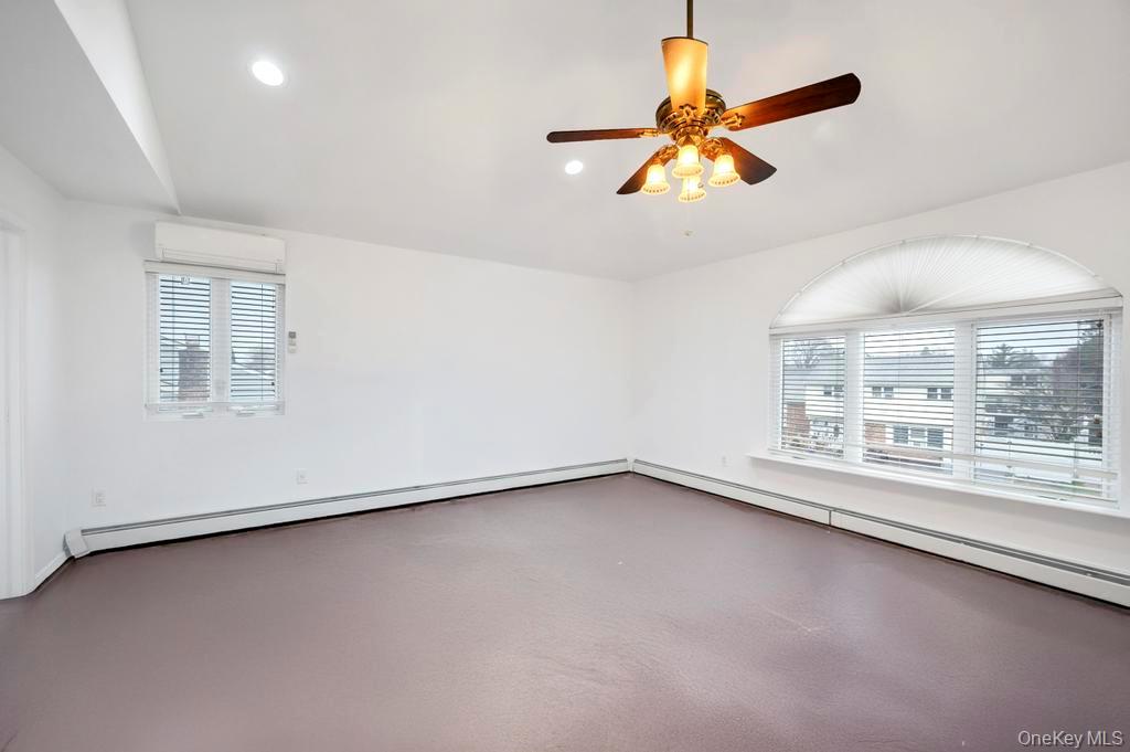 64 Fox Place Hicksville, NY 11801 - Photo 10 of 25 Unfurnished room with a baseboard radiator, recessed lighting, and a ceiling fan
