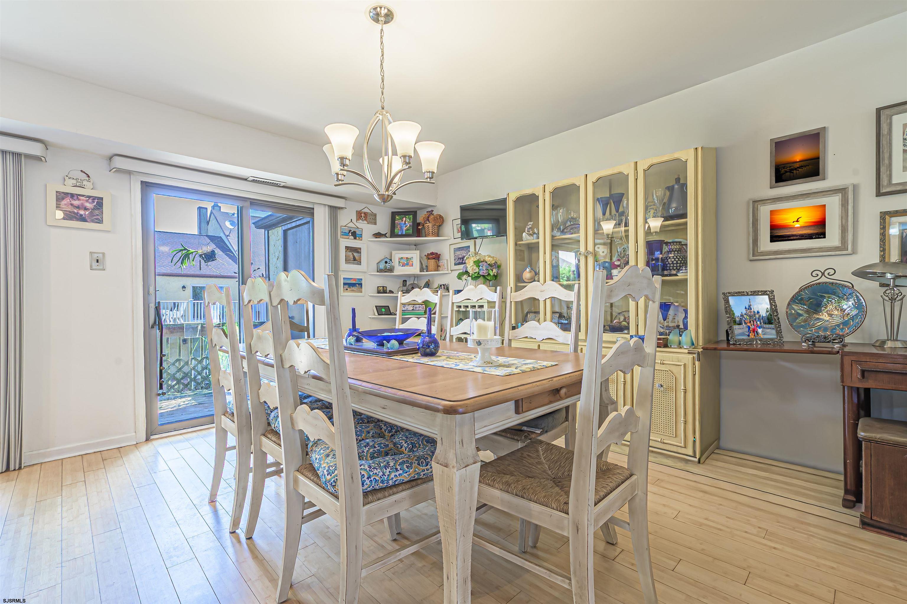 19 Bramble Drive Brigantine, NJ 08203 - Photo 10 of 15 a view of a dining room with furniture a chandelier and wooden floor