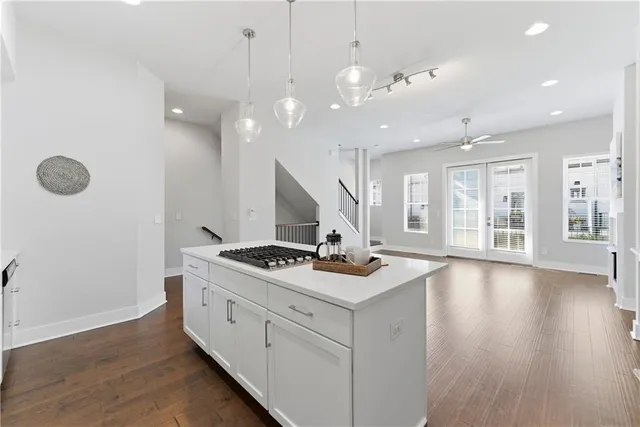 a kitchen with stove and wooden floor