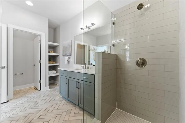 a bathroom with a shower sink and mirror