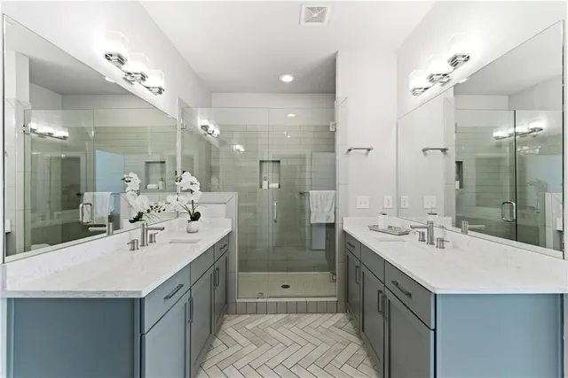 a bathroom with a sink double vanity and a shower