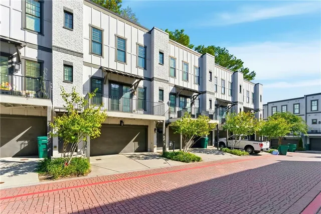 a front view of a multi story residential apartment building with a yard