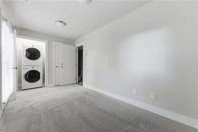 an empty room with a fireplace and wooden floor