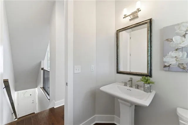 a bathroom with a sink a toilet and mirror