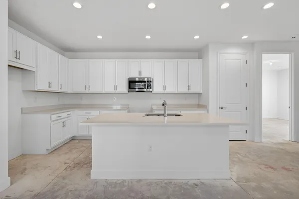a bedroom with a large bed a flat tv screen and a chandelier