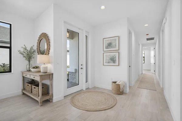 a view of a kitchen with a sink and a refrigerator