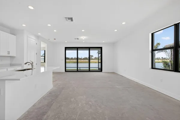 a kitchen with stainless steel appliances white cabinets and a refrigerator