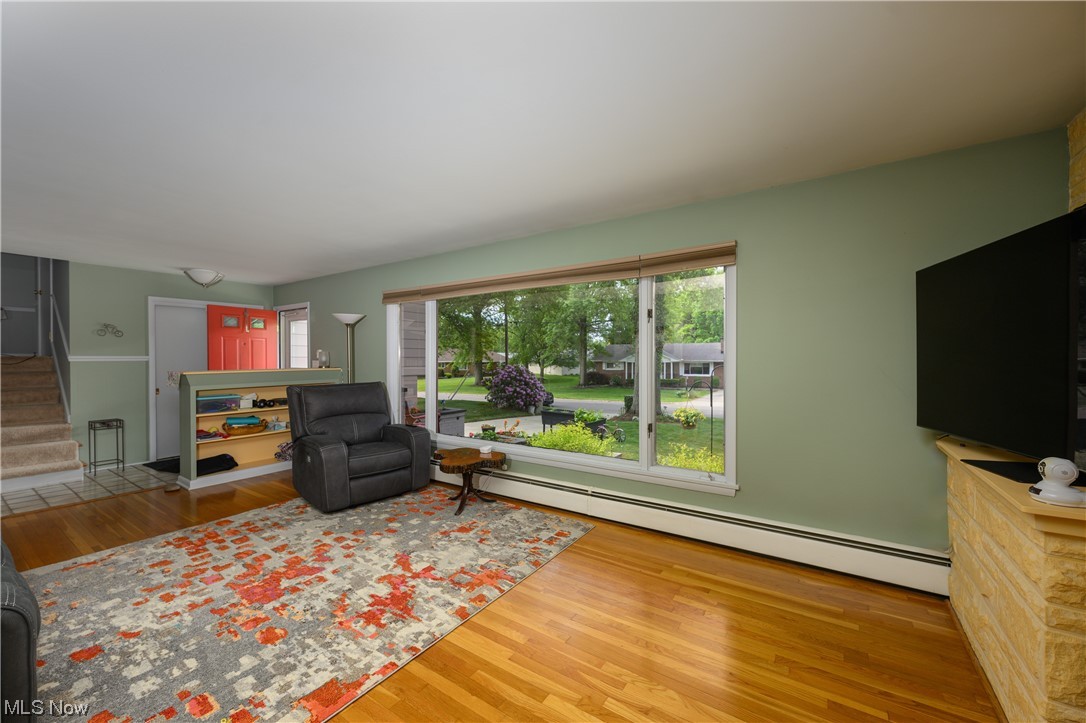 572 Overwood Road Akron, OH 44313 - Photo 9 of 35 Living room with a baseboard heating unit and
Beautiful living room picture window
light hardwood floors