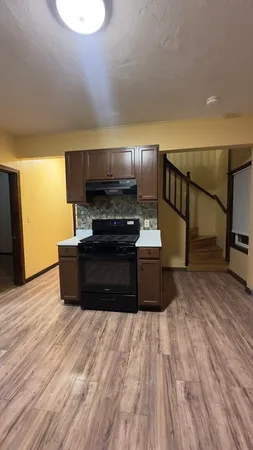 a kitchen with stainless steel appliances a refrigerator and a stove top oven