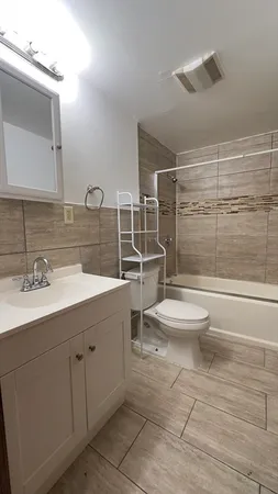 a bathroom with a toilet a sink and shower