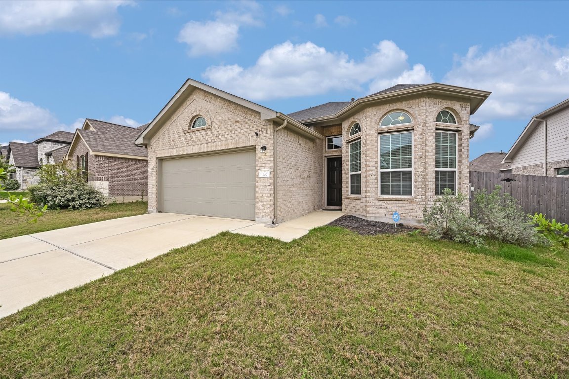 a front view of a house with a garden
