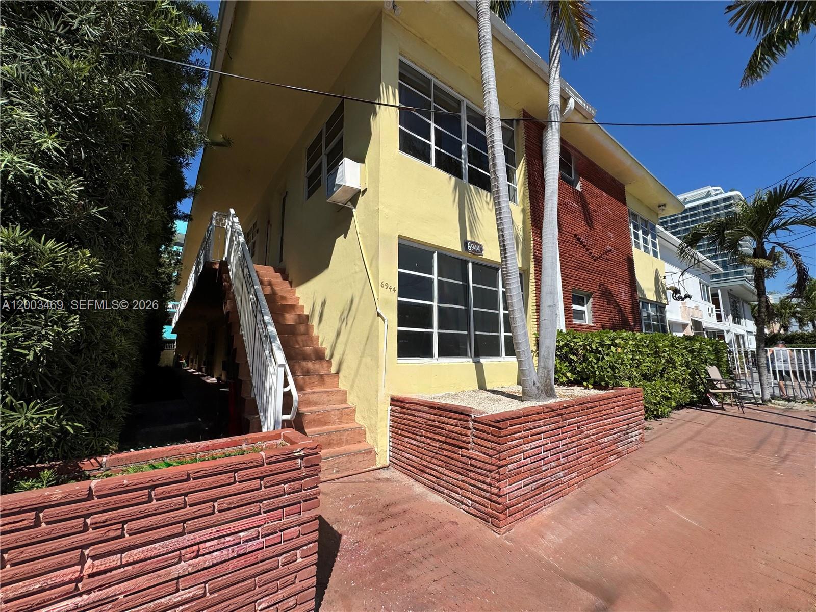 6944 Byron Avenue, Unit 1 Miami Beach, FL 33141 - Photo 15 of 15 a view of a house with a door and a yard