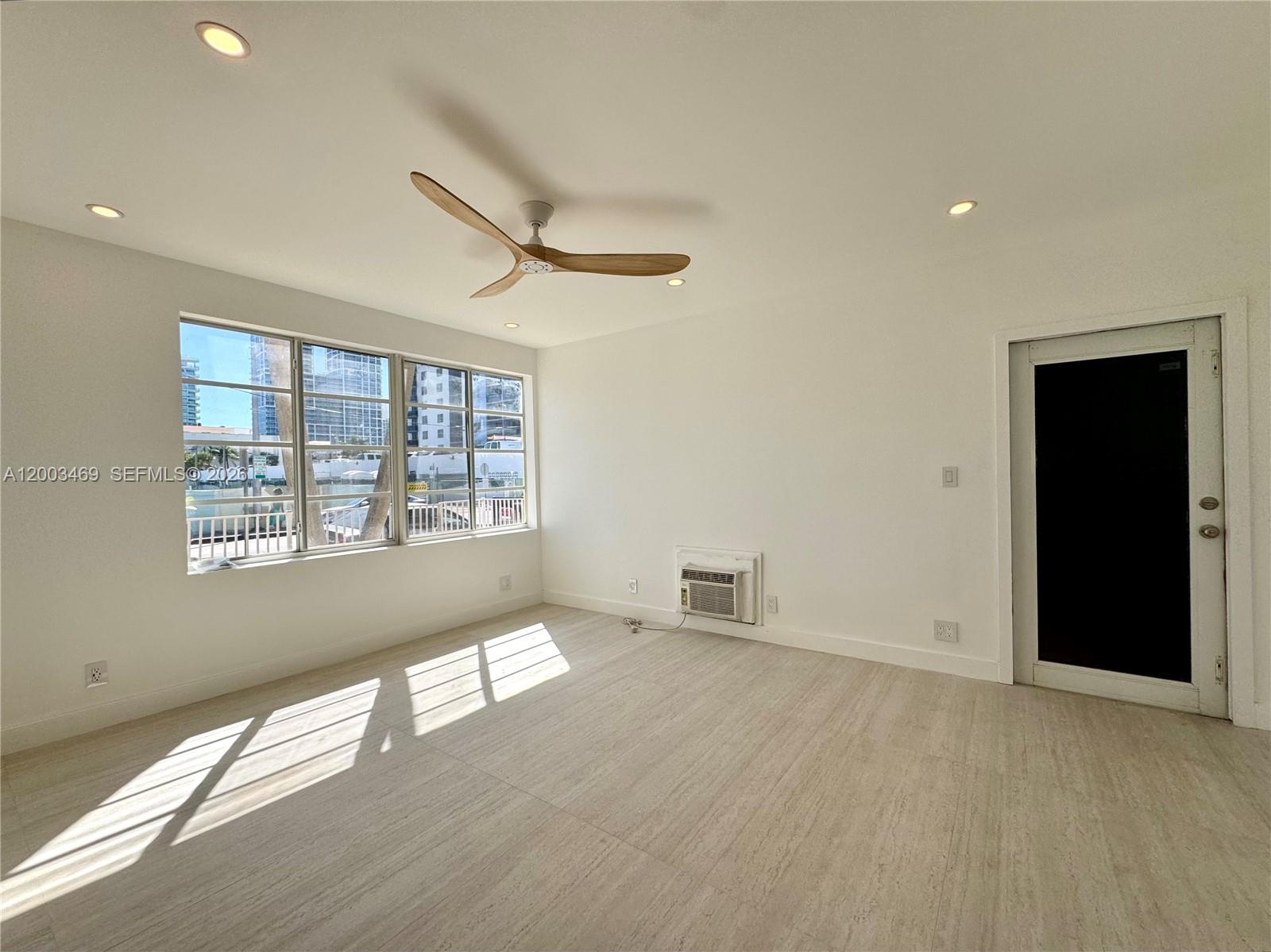 6944 Byron Avenue, Unit 1 Miami Beach, FL 33141 - Photo 3 of 15 a view of an empty room with a window