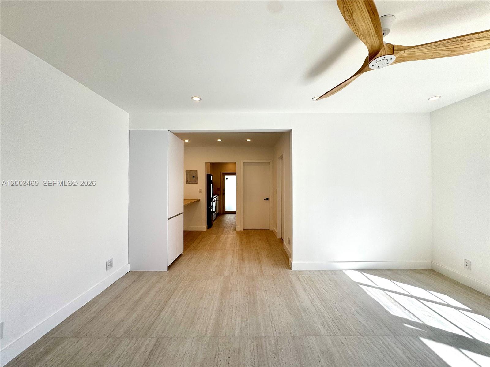 6944 Byron Avenue, Unit 1 Miami Beach, FL 33141 - Photo 4 of 15 a view of a hallway with wooden floor