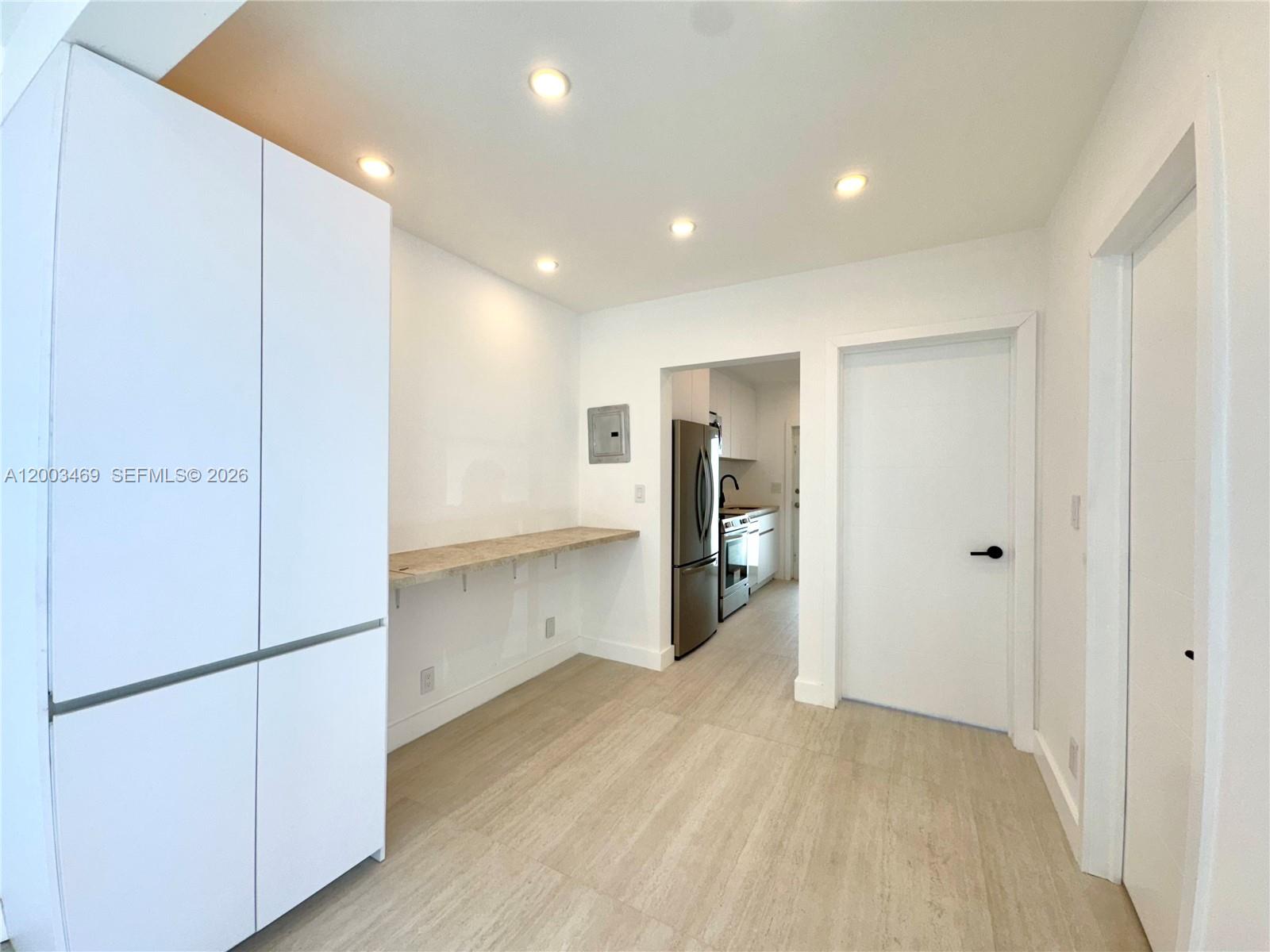 6944 Byron Avenue, Unit 1 Miami Beach, FL 33141 - Photo 5 of 15 a view of an empty room with wooden floor
