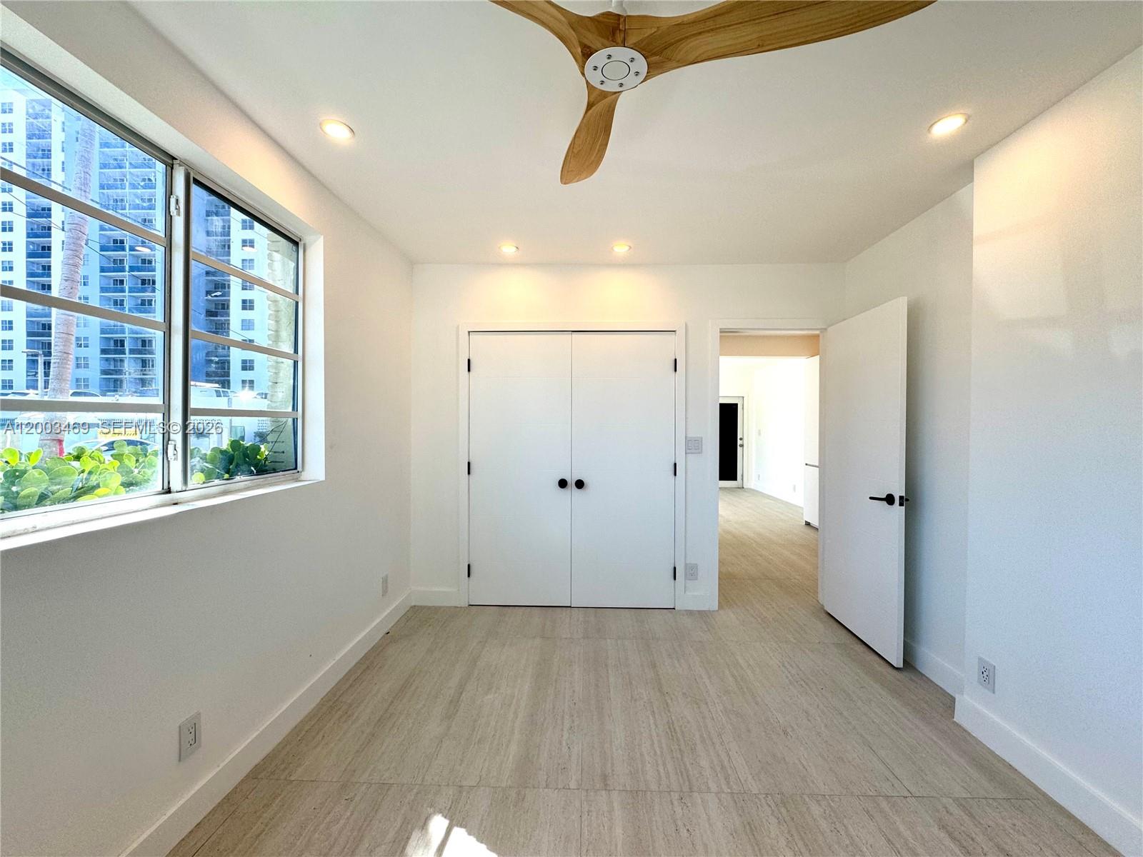 6944 Byron Avenue, Unit 1 Miami Beach, FL 33141 - Photo 8 of 15 a view of a big room with windows and closet