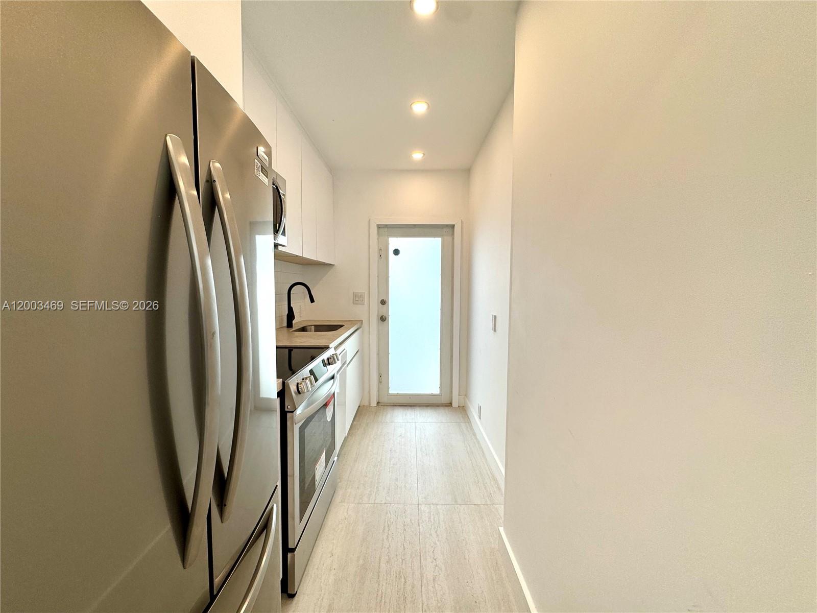 6944 Byron Avenue, Unit 1 Miami Beach, FL 33141 - Photo 10 of 15 a view of a refrigerator in kitchen and entryway