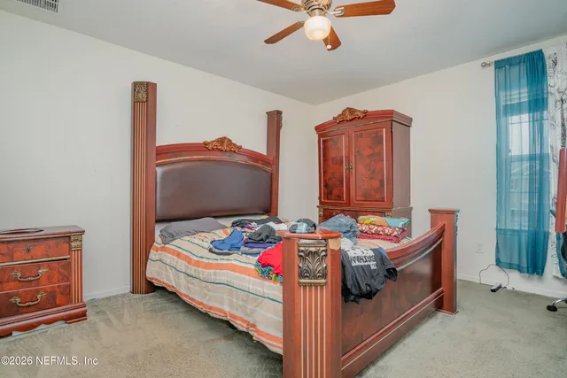 a bedroom with bed and window